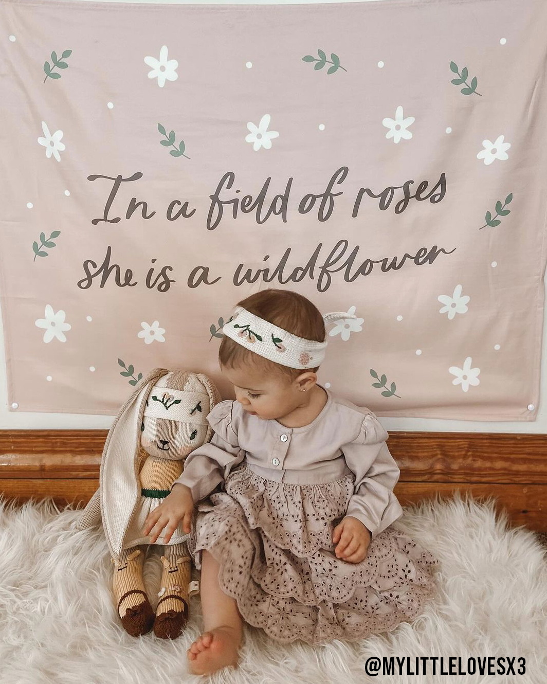 In A Field of Roses She Is A Wildflower Banner: Small 17x13"